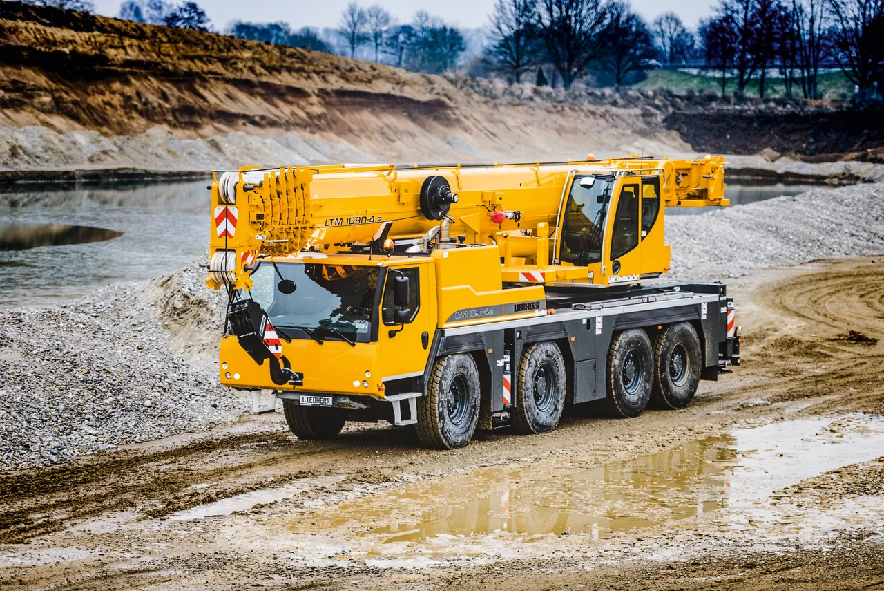 Yellow Liebherr LTM 1090-4.2 all-terrain crane on a work site
